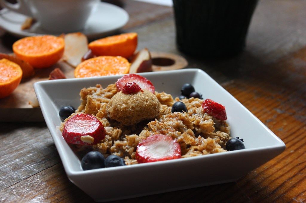A bowl of granola joins a cutting board filled with fruit to stimulate discussion.