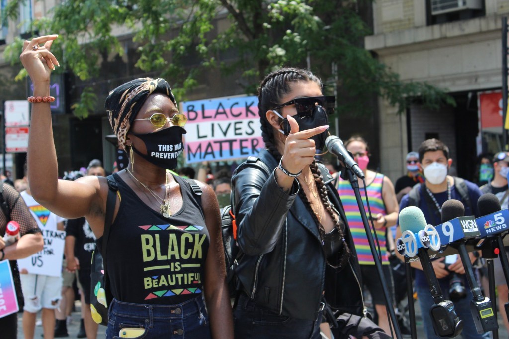 Ashabi Owagboriaye (left) and Alexis Abarca (right) speak during Sunday's "Pride Without Prejudice / Reclaim Pride" protest. | Jake Wittich/Block Club Chicago