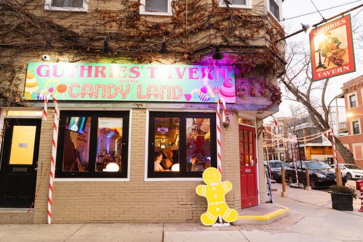 12-foot candy canes line the outside of Guthries Tavern for its holiday pop-up.