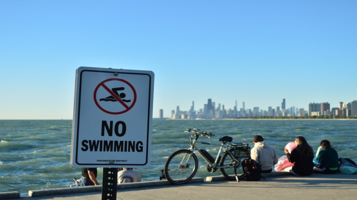 Newly-erected signage at Montrose Harbor follows tension between Friday Morning Swim Club and the Park District.